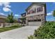 Two-story home features stone accents, red shutters, landscaped lawn, attached two car garage, and concrete driveway at 5789 Echo Park Cir, Castle Rock, CO 80104