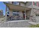 Inviting front porch with stone accents and room to sit and enjoy neighborhood views at 5789 Echo Park Cir, Castle Rock, CO 80104
