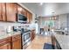 The kitchen features stainless steel appliances, granite countertops, and wooden floors at 5789 Echo Park Cir, Castle Rock, CO 80104