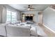 Living room featuring a large sectional sofa, a ceiling fan, and natural light from a window at 5789 Echo Park Cir, Castle Rock, CO 80104