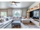 Cozy living room with a large sectional sofa, ceiling fan, and a view of the outdoors at 5789 Echo Park Cir, Castle Rock, CO 80104