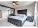 A large main bedroom featuring a large platform bed, neutral colors and carpet at 5789 Echo Park Cir, Castle Rock, CO 80104