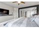 This main bedroom features a television, neutral walls and carpeting, and bright natural light at 5789 Echo Park Cir, Castle Rock, CO 80104