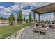Covered patio with string lights and wood fixtures creates a relaxing backyard space at 5789 Echo Park Cir, Castle Rock, CO 80104