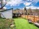 Backyard with new artificial turf, wooden fence, and chairs overlooking the mountains at 2733 S Riverview Dr, Idledale, CO 80453