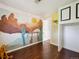 bedroom features a custom mural wall, built-in storage, and wood floors at 2733 S Riverview Dr, Idledale, CO 80453