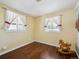 Cozy bedroom with hardwood floors, natural lighting, and charming rocking horse decor at 2733 S Riverview Dr, Idledale, CO 80453