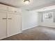 Empty bedroom features built-in storage, neutral carpet, and a sunny window at 2733 S Riverview Dr, Idledale, CO 80453