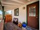 Charming front porch with wood floors, a cozy bench, and a decorative front door at 2733 S Riverview Dr, Idledale, CO 80453