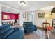 Comfortable living room features blue accent chairs, wood floors, and a decorative rug at 2733 S Riverview Dr, Idledale, CO 80453