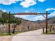 Lair o' the Bear Park entrance featuring a wooden archway, road, and mountain backdrop on a sunny day at 2733 S Riverview Dr, Idledale, CO 80453
