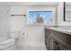 Modern bathroom with dark vanity, marble tile, and large window at 245 Fair Pl, Boulder, CO 80302