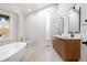 Elegant bathroom with double sinks, a soaking tub, and modern fixtures at 245 Fair Pl, Boulder, CO 80302