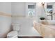 Powder room with floating vanity, wave wall tile, and natural light at 245 Fair Pl, Boulder, CO 80302