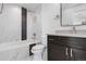 Modern bathroom with dark vanity, marble tile and shower/tub combo at 245 Fair Pl, Boulder, CO 80302