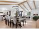 Open dining room area featuring vaulted ceilings, wood beams, and a stone fireplace at 245 Fair Pl, Boulder, CO 80302
