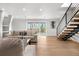 Bright living room with hardwood floors, modern furniture, and sliding glass doors leading to a deck at 245 Fair Pl, Boulder, CO 80302