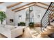 Bright living room with fireplace, hardwood floors, beamed ceilings, and spiral staircase at 245 Fair Pl, Boulder, CO 80302