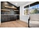 Modern wet bar with dark cabinetry, floating shelves, and wine cooler at 245 Fair Pl, Boulder, CO 80302
