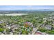 Idyllic aerial view of a charming home surrounded by verdant trees, a serene lake and mountain backdrop at 2844 Quitman St, Denver, CO 80212