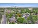 Lovely aerial view of a home nestled among lush green trees, with city skyline views in the background at 2844 Quitman St, Denver, CO 80212