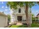 Charming backyard featuring covered patio, lush lawn, and mature trees at 2844 Quitman St, Denver, CO 80212