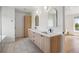 Bright bathroom with double vanity, modern fixtures, and arched mirrors offering a stylish and functional space at 2844 Quitman St, Denver, CO 80212