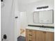 Stylist bathroom featuring wood vanity with sleek hardware and a walk-in shower with white tile at 2844 Quitman St, Denver, CO 80212