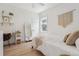 Cozy bedroom with hardwood floors, a comfortable bed, a ceiling fan, and a well-lit desk area at 2844 Quitman St, Denver, CO 80212