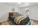 Inviting bedroom with a cozy green comforter, decorative throw pillows, and modern decor creating a relaxing retreat at 2844 Quitman St, Denver, CO 80212