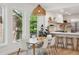 Bright dining area with natural light, a pendant light, and a view of the modern kitchen at 2844 Quitman St, Denver, CO 80212