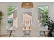 Sunlit dining room with a wooden table, white chairs, and views of the backyard at 2844 Quitman St, Denver, CO 80212
