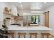 Modern kitchen with an island, stainless steel appliances, and a view into the living space at 2844 Quitman St, Denver, CO 80212