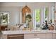 Modern kitchen showcasing white countertops, brass faucet, and an island with pendant lighting at 2844 Quitman St, Denver, CO 80212