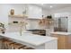Updated kitchen with floating shelves, stainless steel appliances, and quartz countertops at 2844 Quitman St, Denver, CO 80212