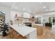 Modern open concept kitchen boasts a large island, floating shelves, and stainless steel appliances at 2844 Quitman St, Denver, CO 80212