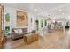 Bright, open-concept living space with hardwood floors seamlessly connects to the dining area and kitchen at 2844 Quitman St, Denver, CO 80212