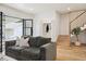 Open living room with hardwood floors, modern staircase, and a comfortable sofa at 2844 Quitman St, Denver, CO 80212