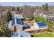 Overhead view of house with solar panels and a backyard with a gazebo and garden boxes at 1744 S Leyden St, Denver, CO 80224