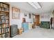 Carpeted basement room with bookcase and sewing station at 1744 S Leyden St, Denver, CO 80224