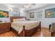 Comfortable bedroom with hardwood floors, ceiling fan, and decorative art at 1744 S Leyden St, Denver, CO 80224