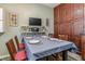 Dining area adjacent to kitchen, with a wood table for six and wooden cabinets at 1744 S Leyden St, Denver, CO 80224