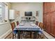 Dining room with wooden table set for six, accented by a large window and built-in cabinets at 1744 S Leyden St, Denver, CO 80224