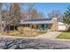 Charming brick home featuring solar panels, a landscaped front yard, and a welcoming pergola at 1744 S Leyden St, Denver, CO 80224