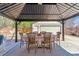 Outdoor gazebo with a table and chairs for backyard entertaining next to detached garage at 1744 S Leyden St, Denver, CO 80224