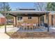 Outdoor gazebo with a welcome sign, table and chairs for backyard entertaining at 1744 S Leyden St, Denver, CO 80224
