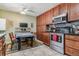 Kitchen with wood cabinets, stainless steel appliances, and a table for six at 1744 S Leyden St, Denver, CO 80224
