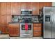 Well-appointed kitchen features stainless steel appliances, sleek countertops, and wood cabinets at 1744 S Leyden St, Denver, CO 80224