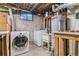 Functional laundry area features modern washer/dryer, utility sink, and water heater at 1744 S Leyden St, Denver, CO 80224
