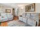 Comfortable living room featuring hardwood floors, neutral colors, and reclining sofas at 1744 S Leyden St, Denver, CO 80224